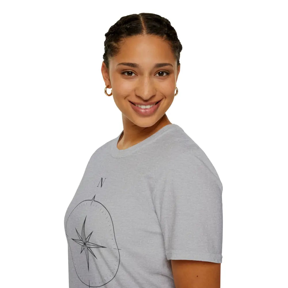 Woman with braided hair and hoop earrings wearing a light gray compass graphic T-shirt for outdoor activities