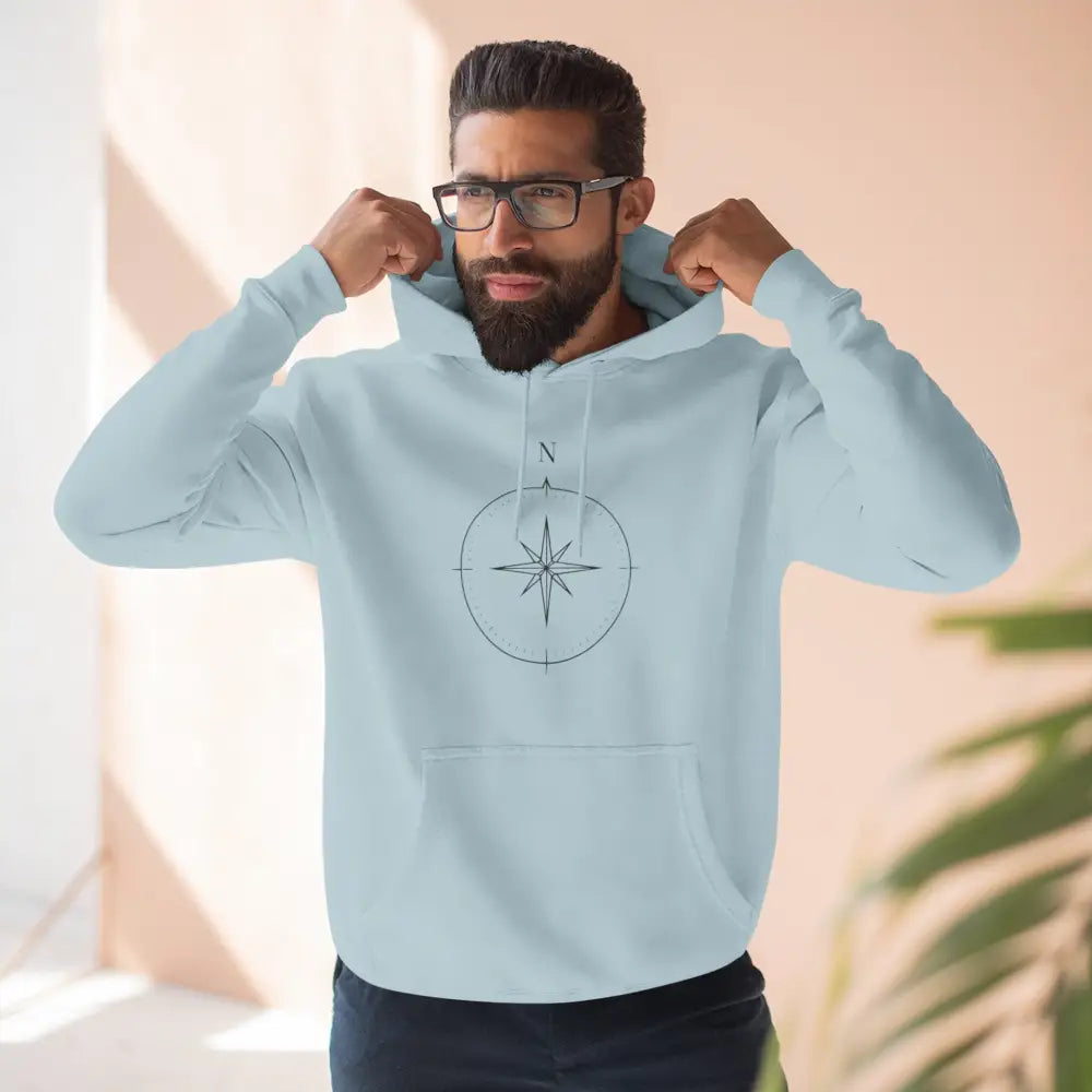 Light blue Cozy Compass unisex hoodie with black compass rose, adjustable hood, low heat care