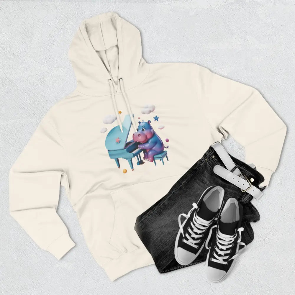 Cream-colored fleece hoodie with whimsical hippo playing piano graphic, perfect for kids and teens