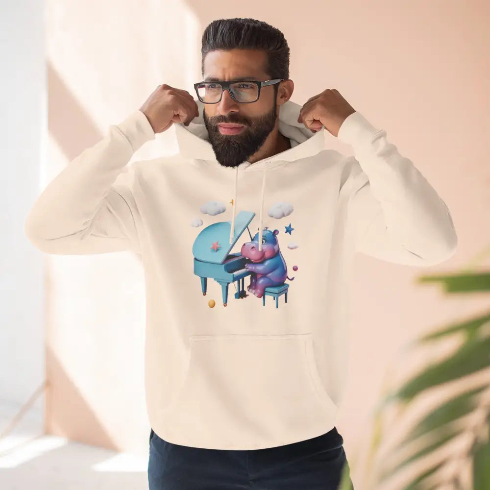 Man wearing a cream-colored fleece hoodie with a cartoon hippo playing piano, perfect for music lovers