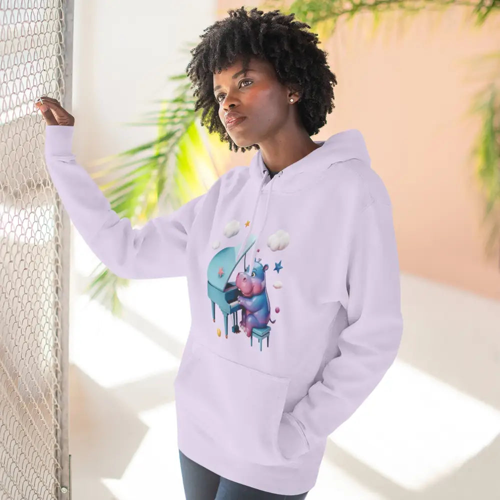 White unisex fleece hoodie with whimsical purple hippo playing teal piano, perfect gift