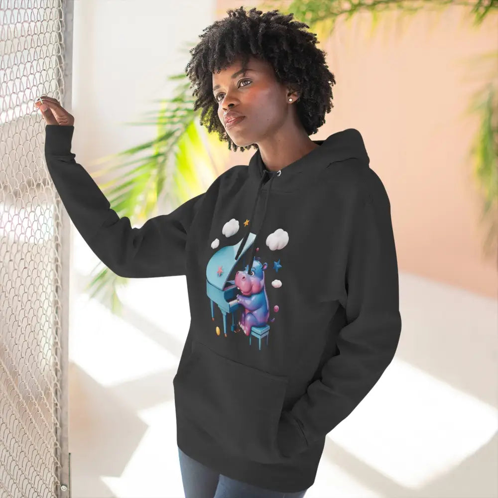 Black unisex fleece hoodie with whimsical animal playing piano graphic, perfect for music lovers
