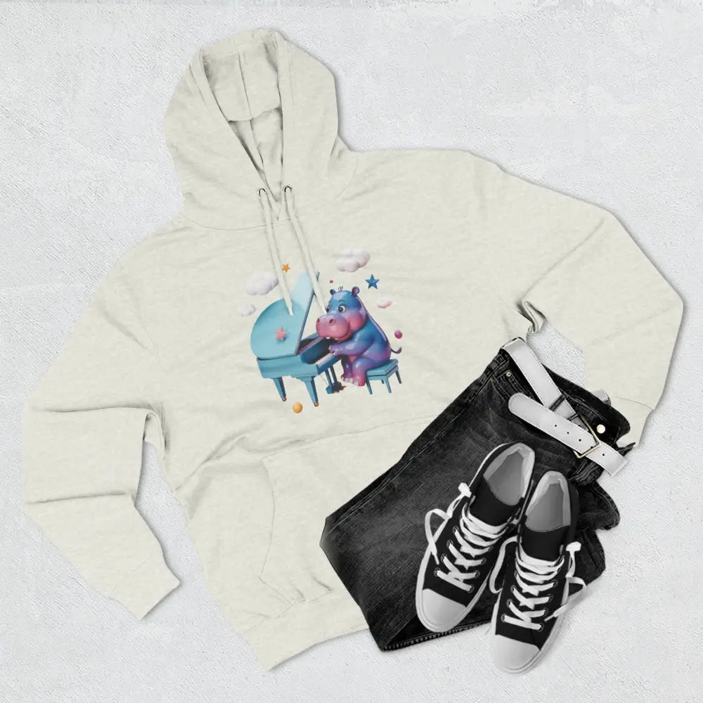 Cream-colored fleece hoodie with whimsical hippo playing piano graphic, perfect for kids and teens
