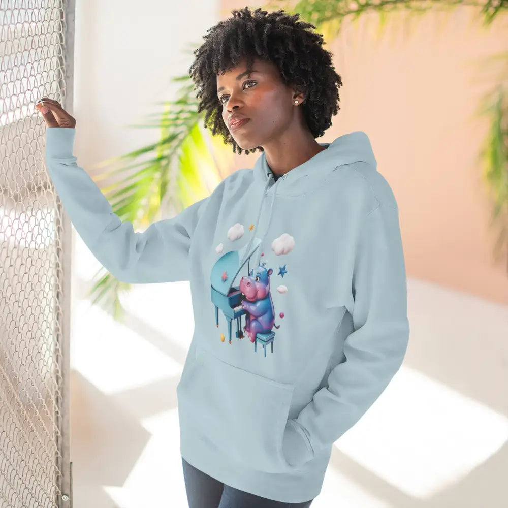 Light blue fleece hoodie with colorful hippo playing piano graphic, perfect for music lovers