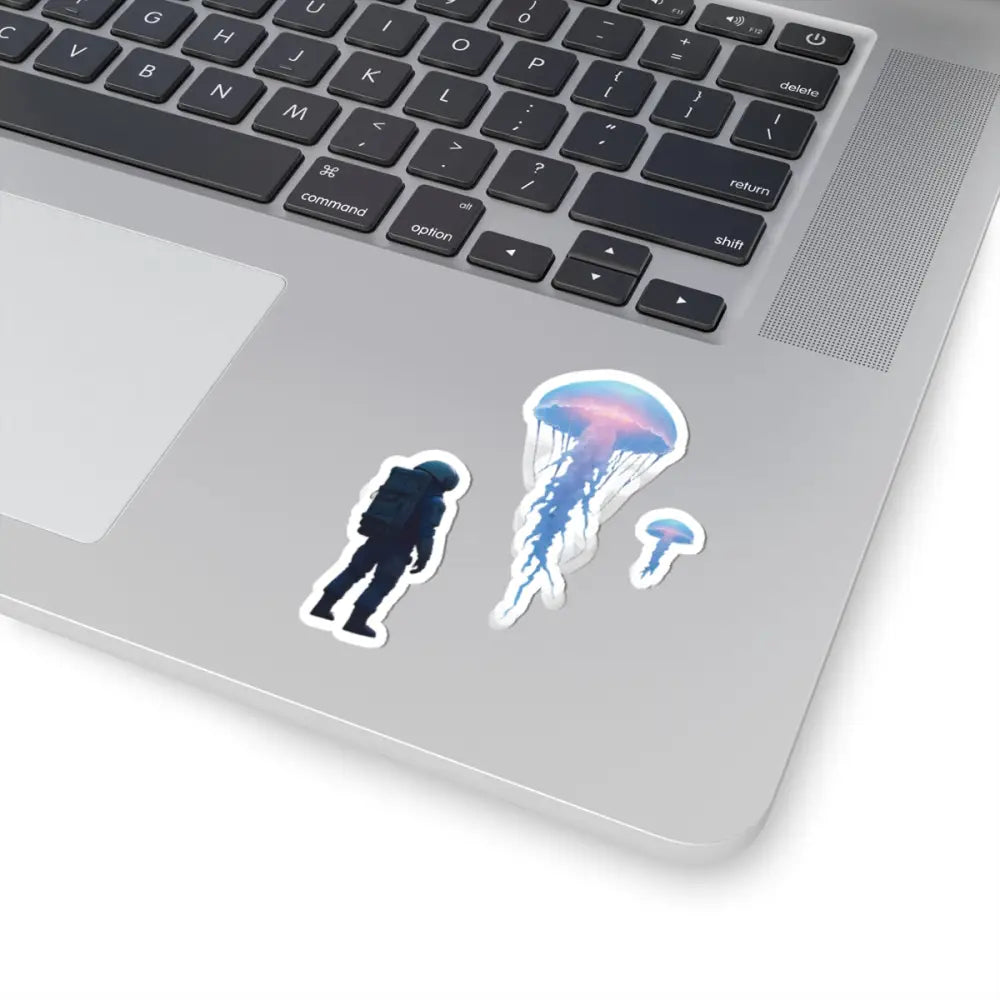 Laptop decorated with astronaut and jellyfish stickers from PixiOnyx Deep Drift Encounter collection