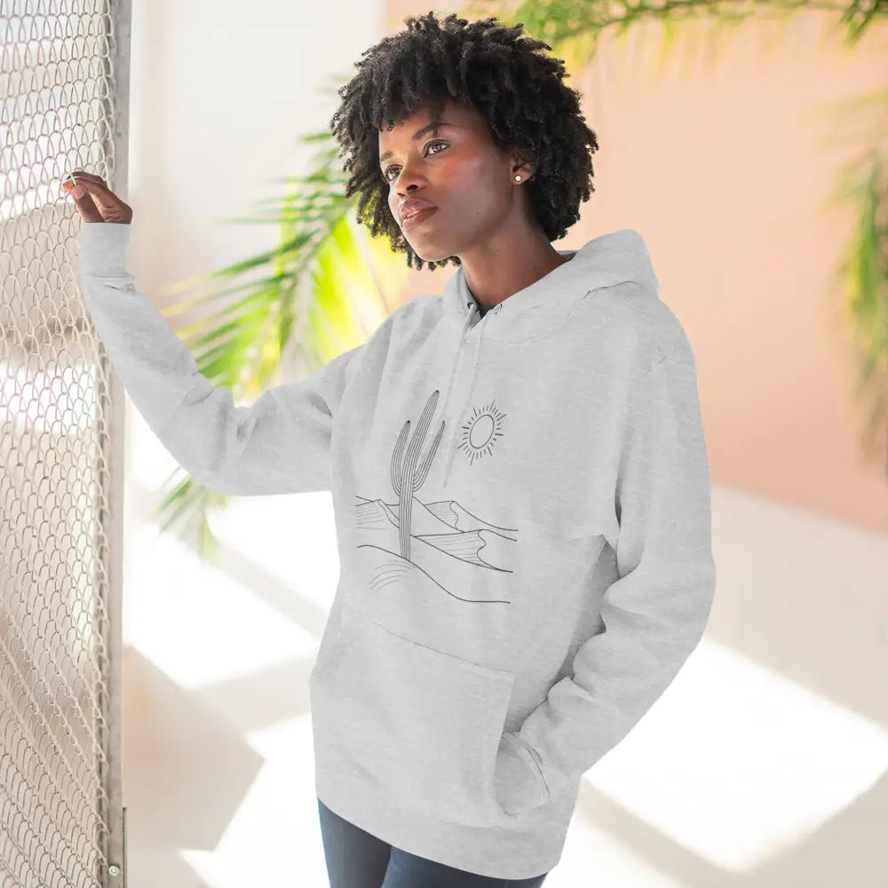 Woman wearing a desert scene three-panel fleece hoodie with spacious kangaroo pocket