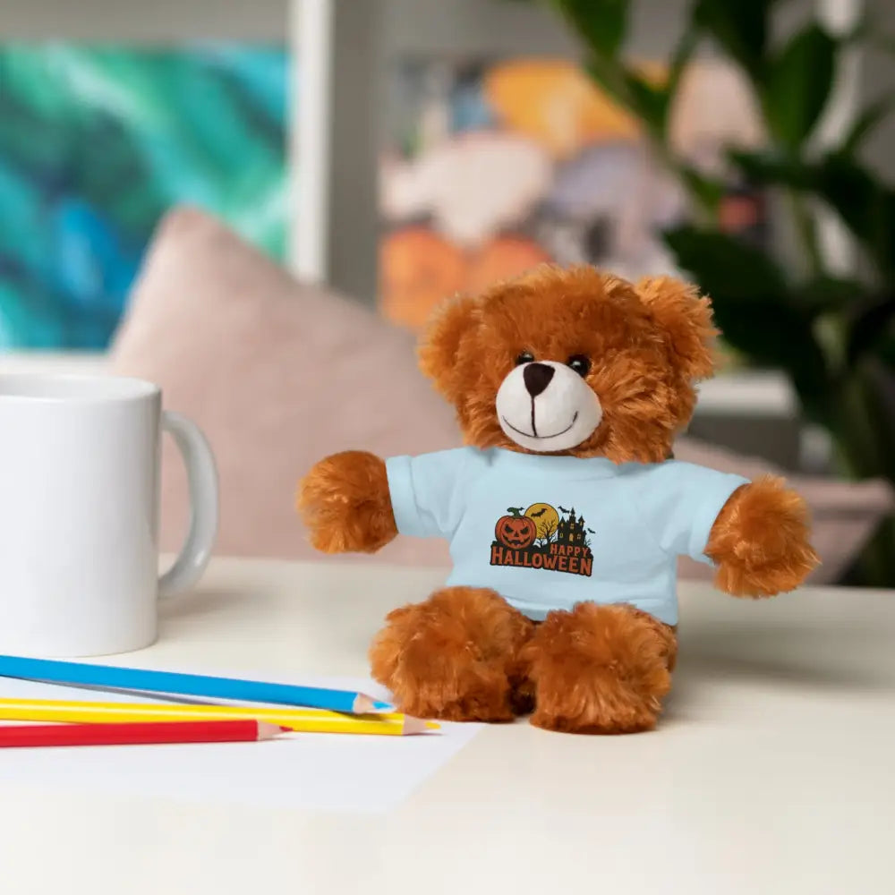 Brown teddy bear wearing a light blue Happy Halloween t-shirt, haunted house themed collectible plush