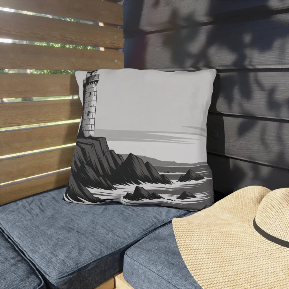 Decorative outdoor pillow with vibrant lighthouse and rocky coastline design for coastal decor