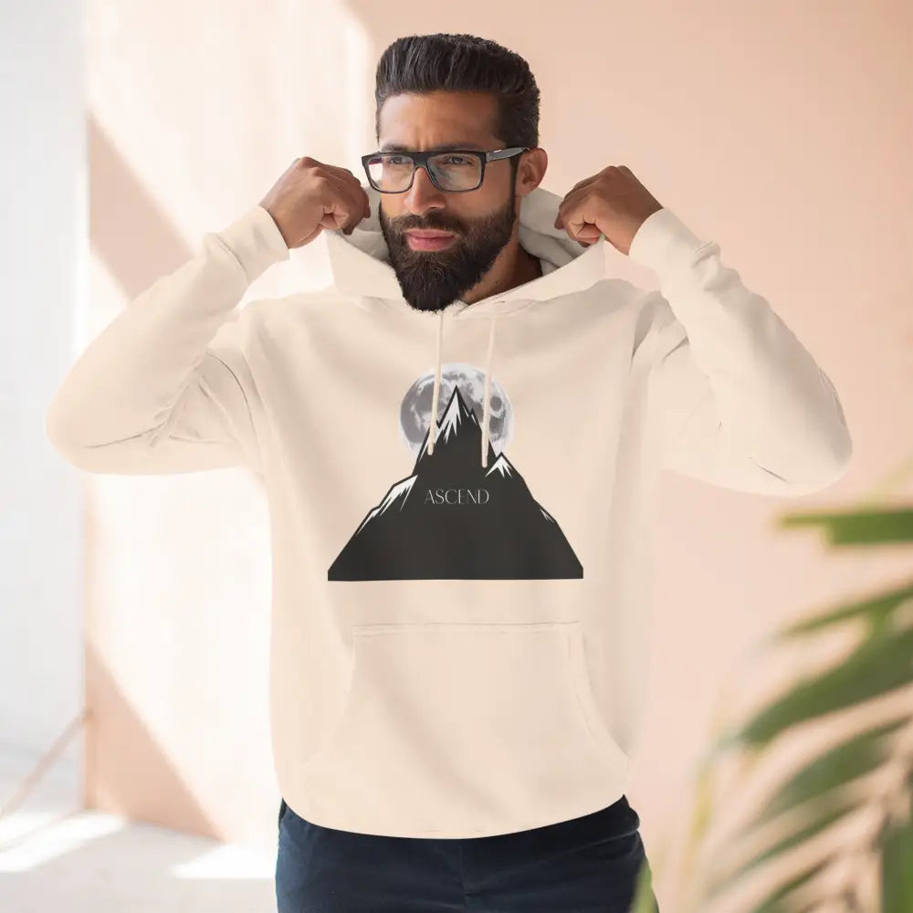 Man wearing cream Mountain Scene Fleece unisex hoodie Ascend with mountain and moon graphic