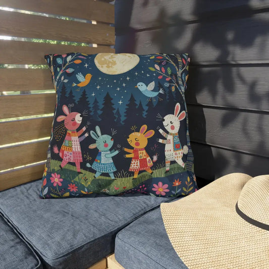 Whimsical outdoor cushion with bunnies dancing under a full moon, perfect for woodland picnic nook