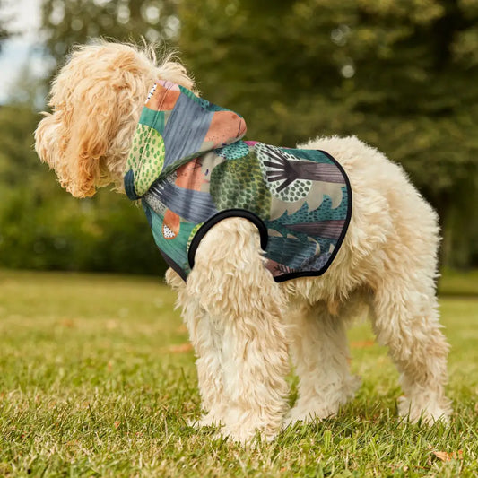 Dog wearing a colorful woodland camo patterned hoodie from PixiOnyx Bold Petwear
