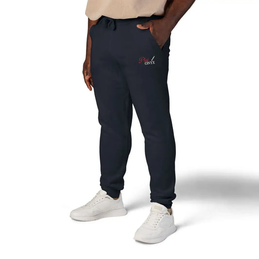 Dark blue cozy unisex fleece sweatpants with red and white logo on left thigh
