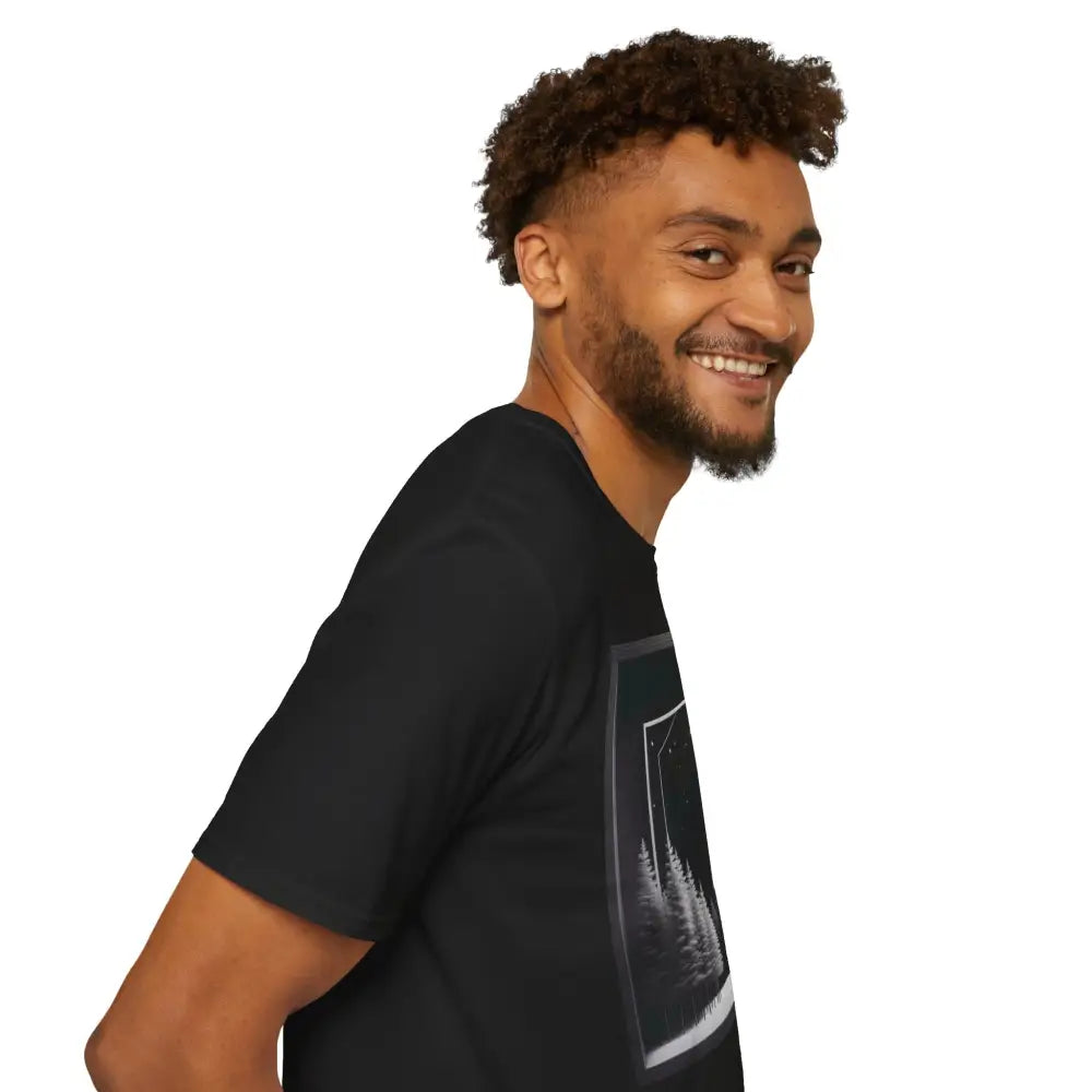 Bearded man with curly hair wearing black graphic T-shirt featuring a serene winter scene for nature lovers