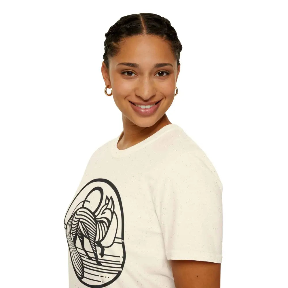 Smiling woman with braided hair wearing a cream-colored T-shirt with abstract fox design, machine washable and tumble dry friendly