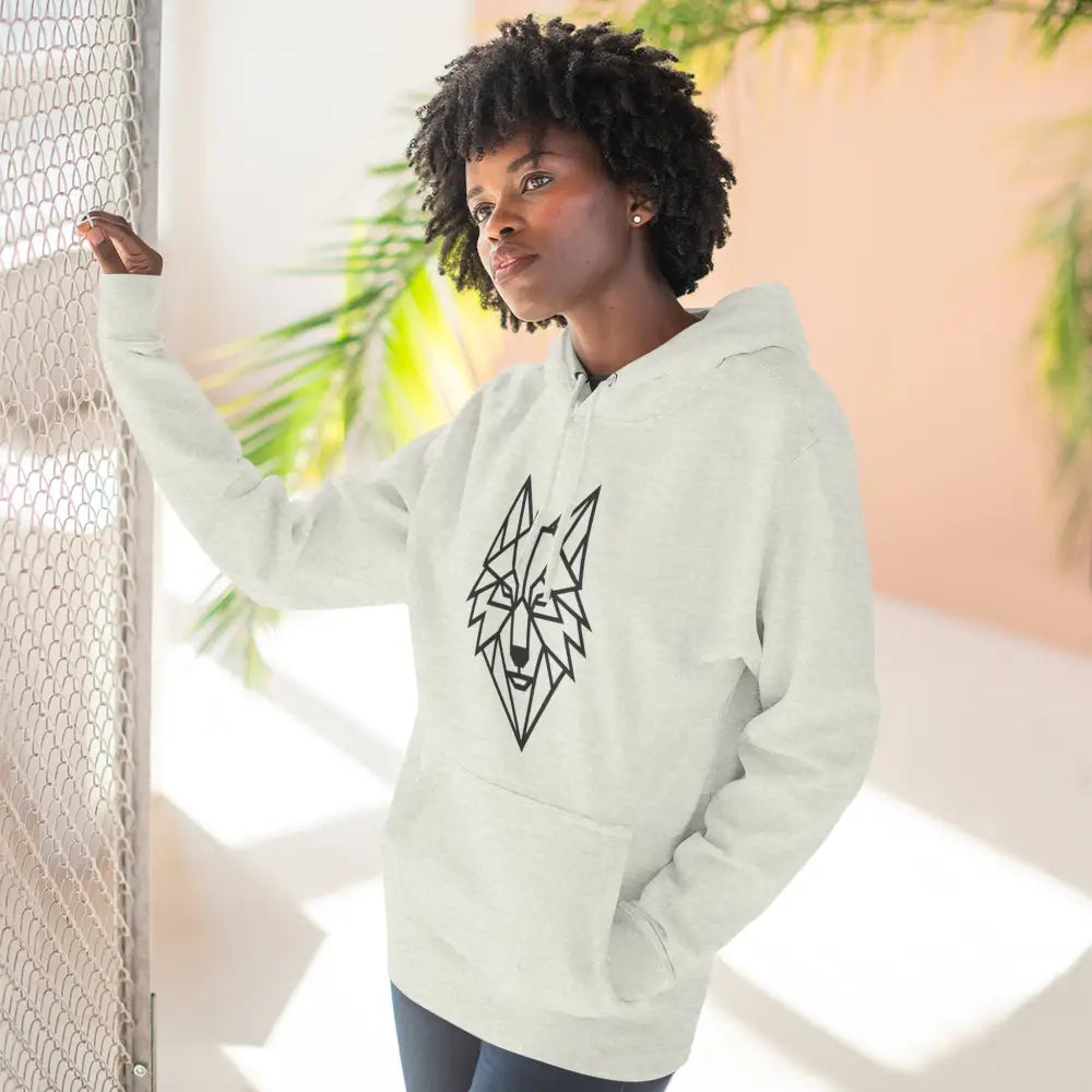 Woman wearing a stylish wolf graphic unisex hoodie with a black geometric wolf design for outdoor adventures