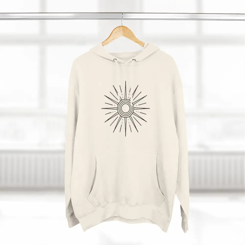 Cream-colored fleece hoodie with black sunburst design and spacious kangaroo pocket for cozy winter layering