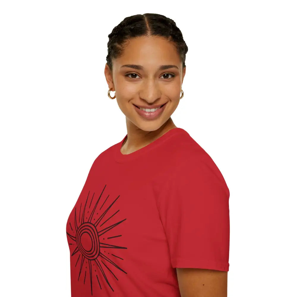Smiling woman with braided hair in a red Sunshine Graphic unisex softstyle T-shirt, ideal for summer outdoor adventures