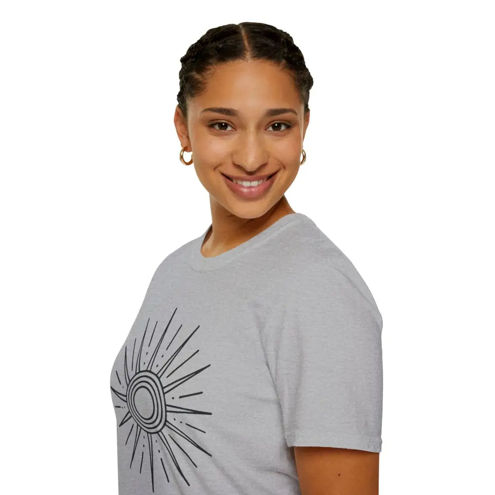 Woman wearing a light gray unisex softstyle T-shirt with black sun graphic, low heat care