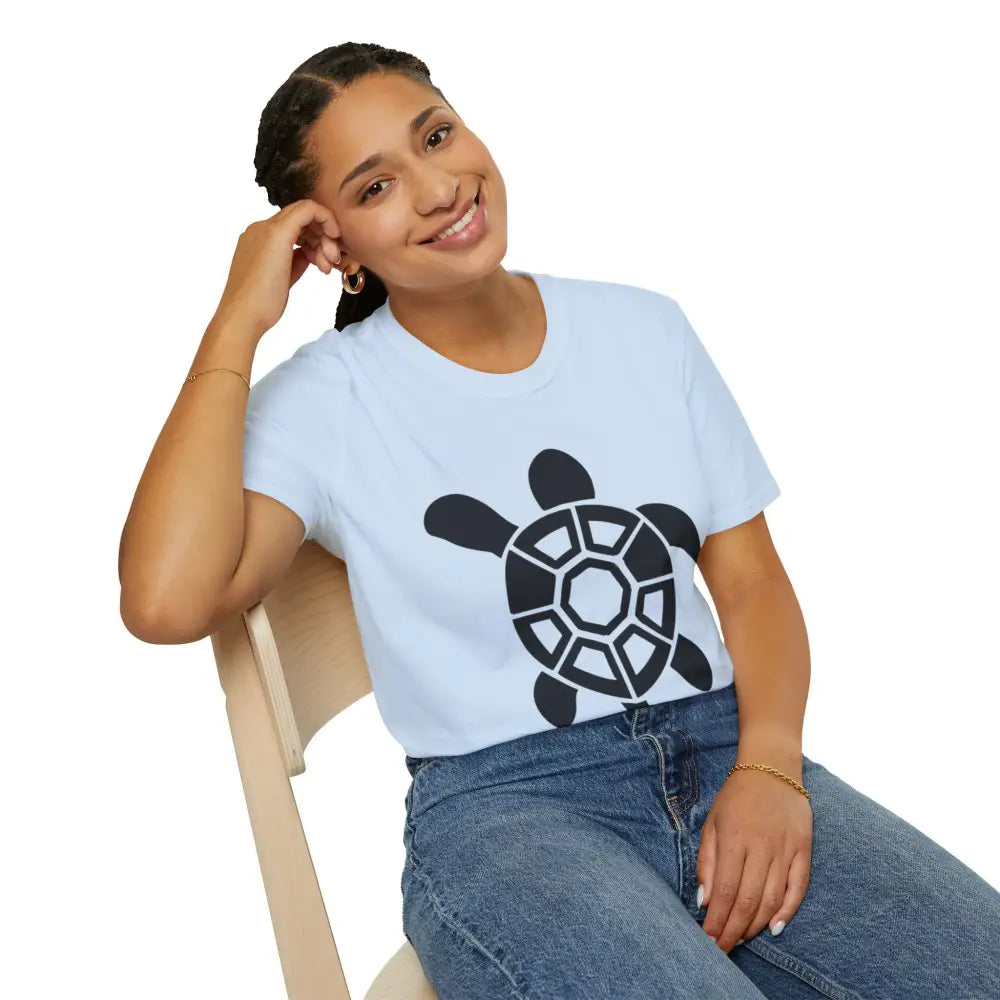 Woman in a light blue Turtle Graphic Unisex Tee with black turtle design, ideal for casual wear and beach days