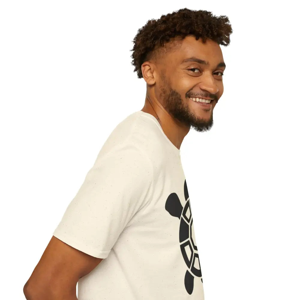 Smiling man with beard and curly hair wearing cream Turtle Graphic Eco-Friendly T-Shirt