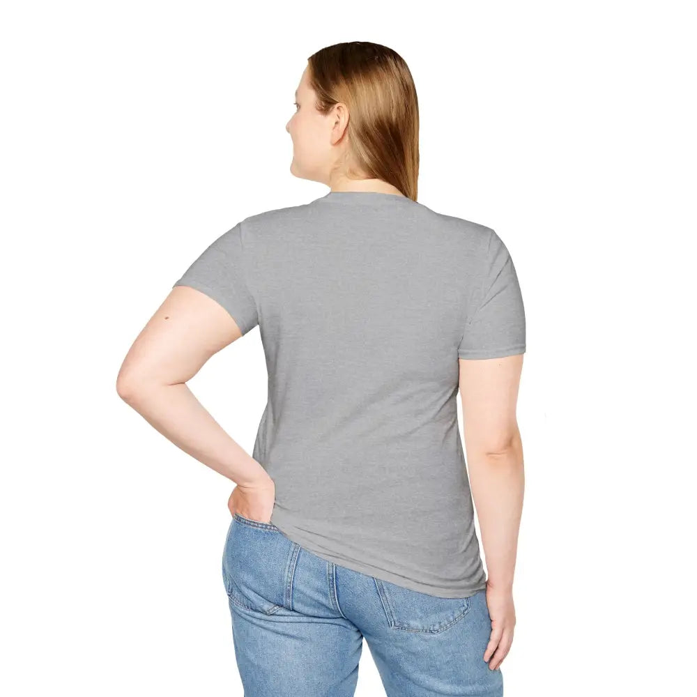Woman in heather gray Turtle Graphic Eco-Friendly T-Shirt with light wash jeans, casual wear