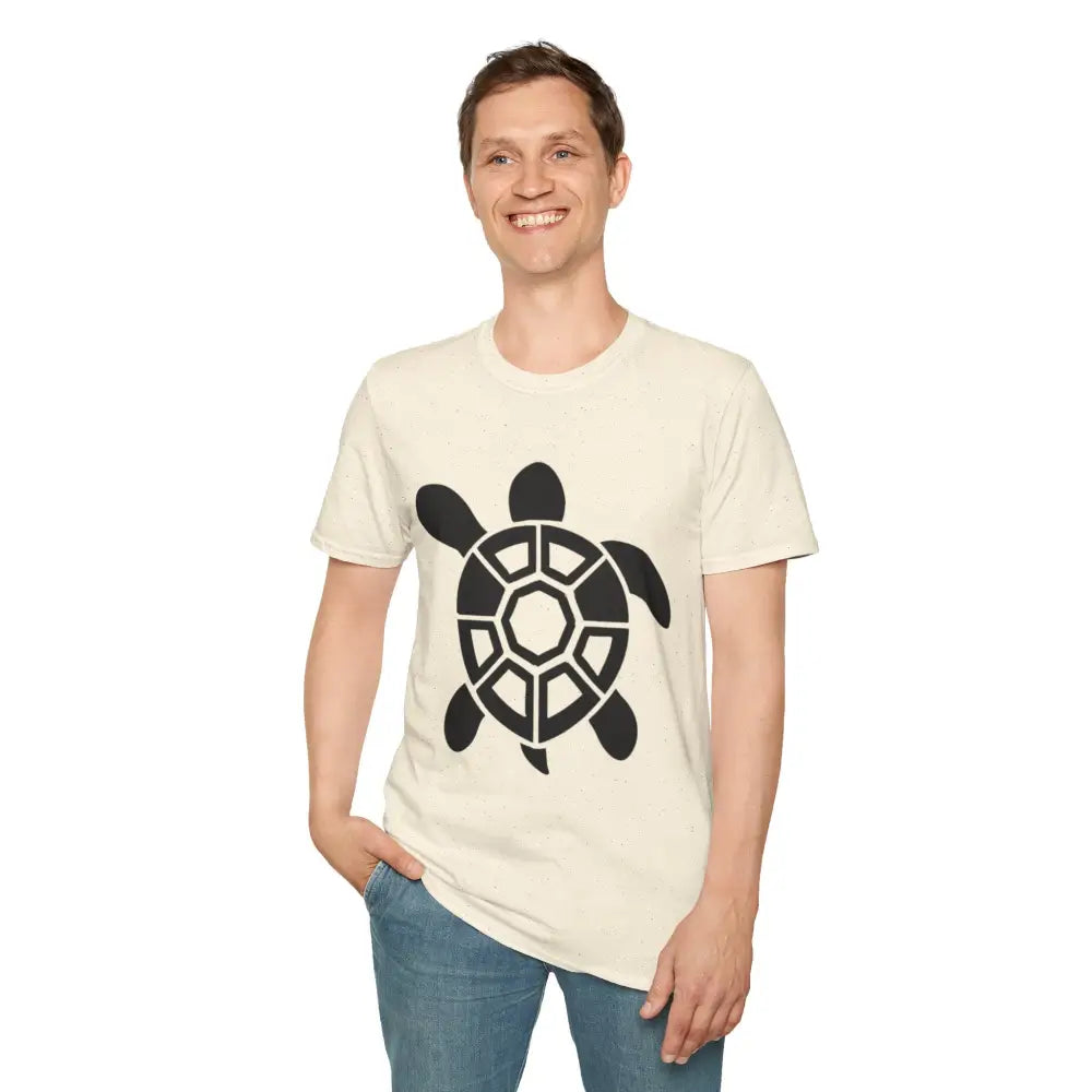 Man in light-colored Turtle Graphic Unisex Tee with black turtle design and blue jeans
