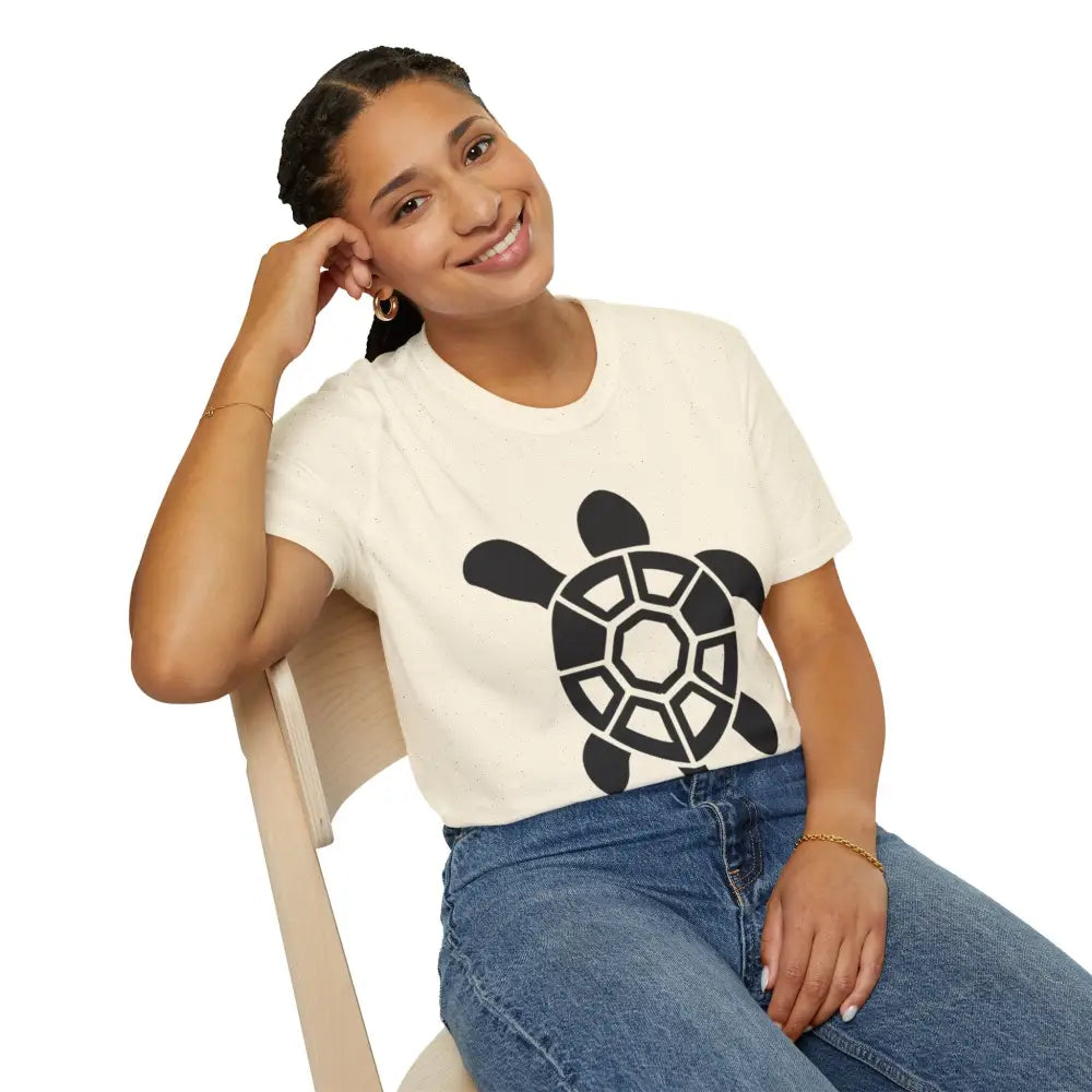 Woman in cream turtle graphic eco-friendly T-shirt and blue jeans, easy care instructions