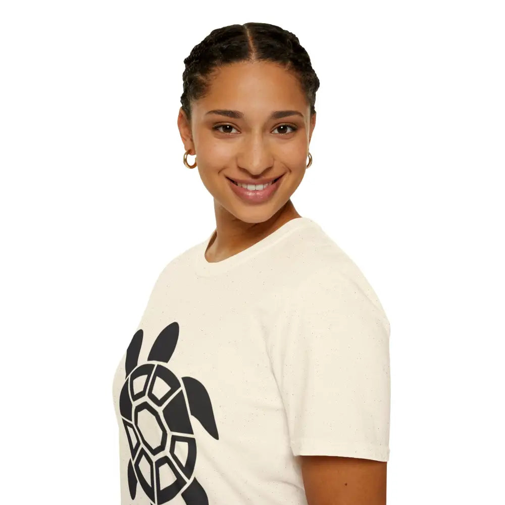 Woman wearing cream Turtle Graphic Unisex Tee, eco-friendly casual wear, easy care