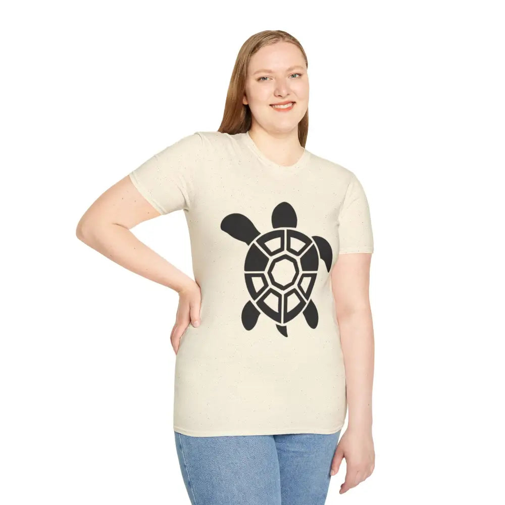 Woman in cream turtle graphic unisex tee and blue jeans, eco-friendly casual wear