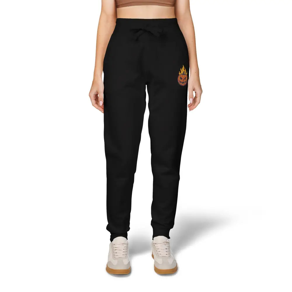 Black women’s fleece sweatpants with flaming pumpkin design on right thigh for cozy Halloween style