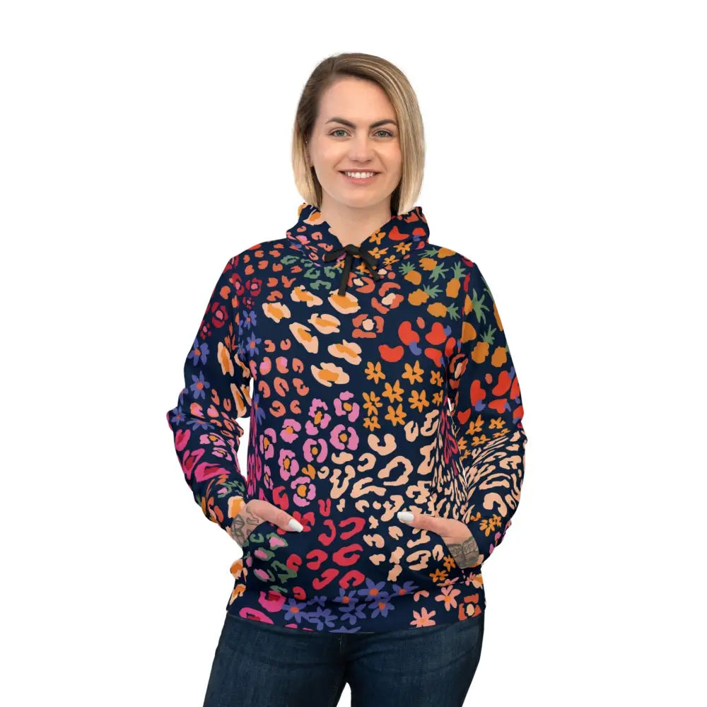 Woman wearing a colorful patterned hoodie from PixiOnyx Chromapulse Spots streetwear collection