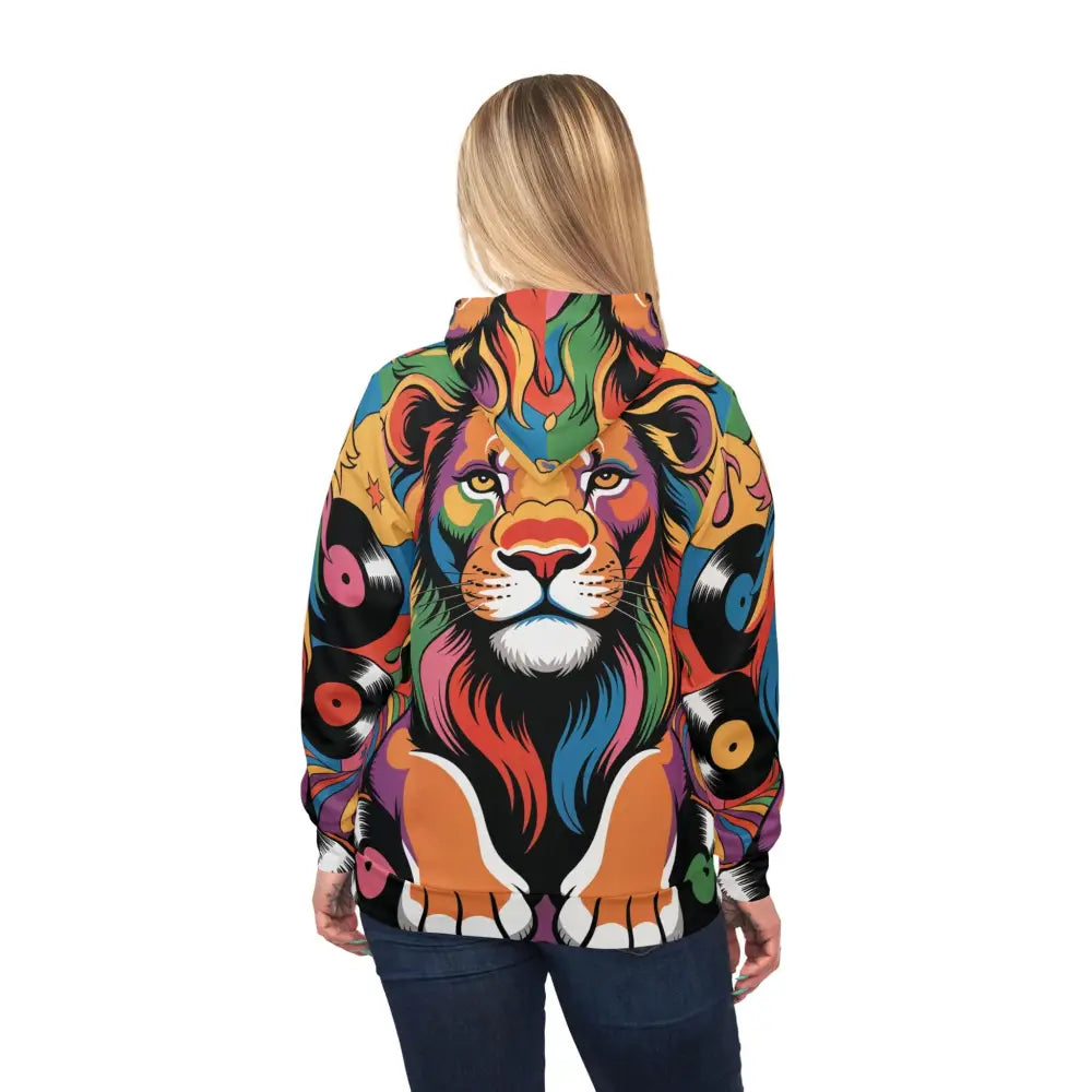 Person wearing a colorful Groove King sweatshirt with lion and vinyl record design