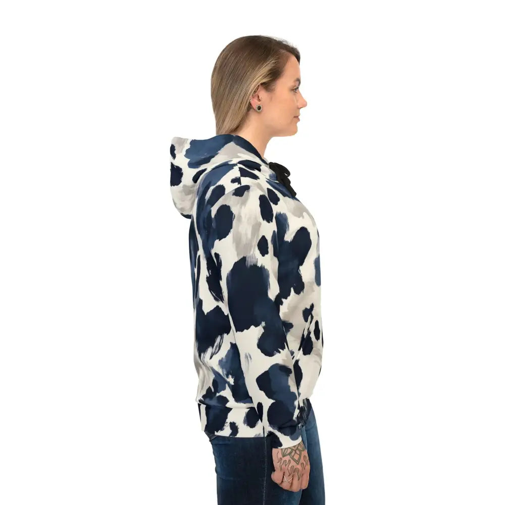 Woman wearing a patterned Inkveil Drift PixiOnyx abstract motionwear unisex hoodie