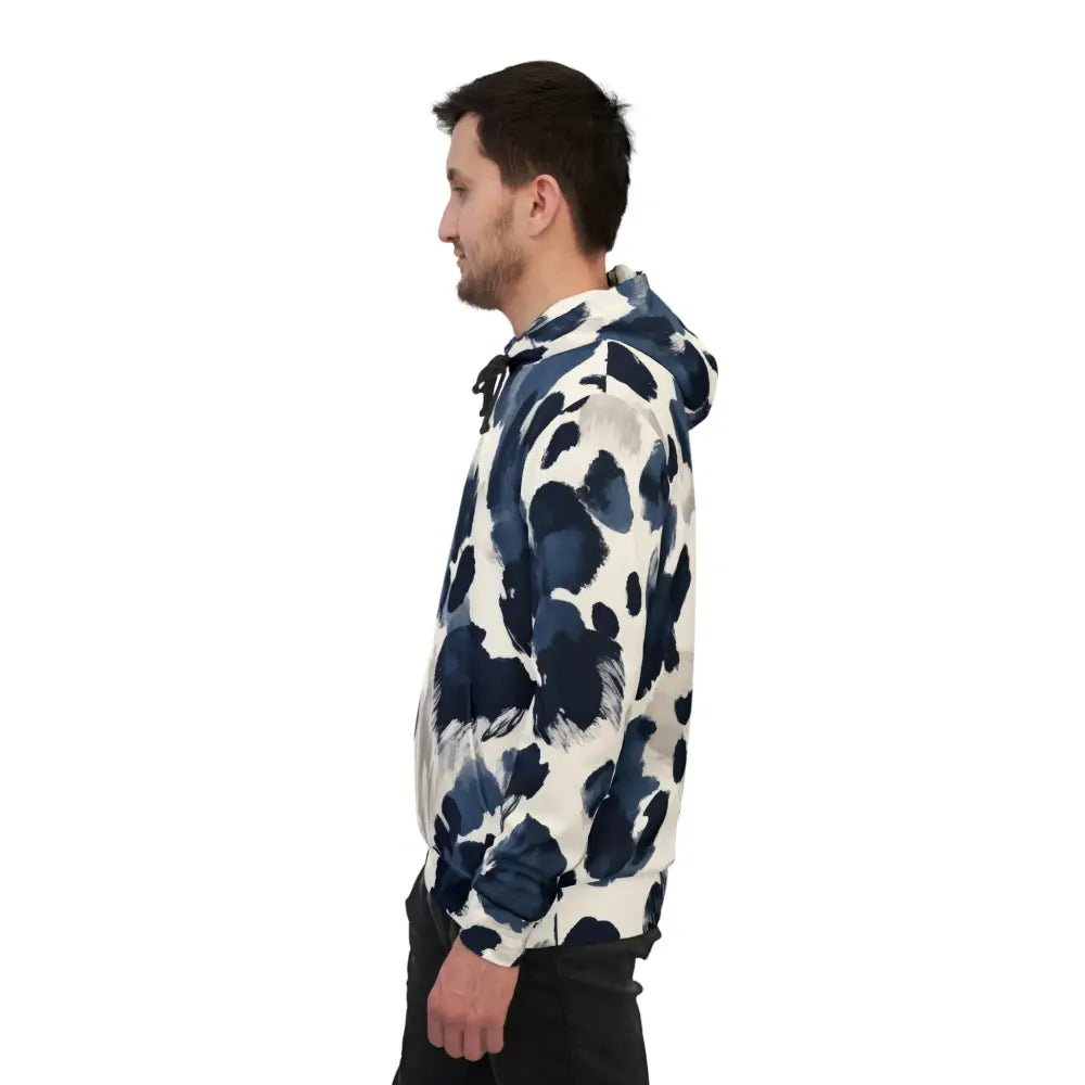 Man in patterned hoodie from Unisex Hoodie Inkveil Drift PixiOnyx Abstract Motionwear