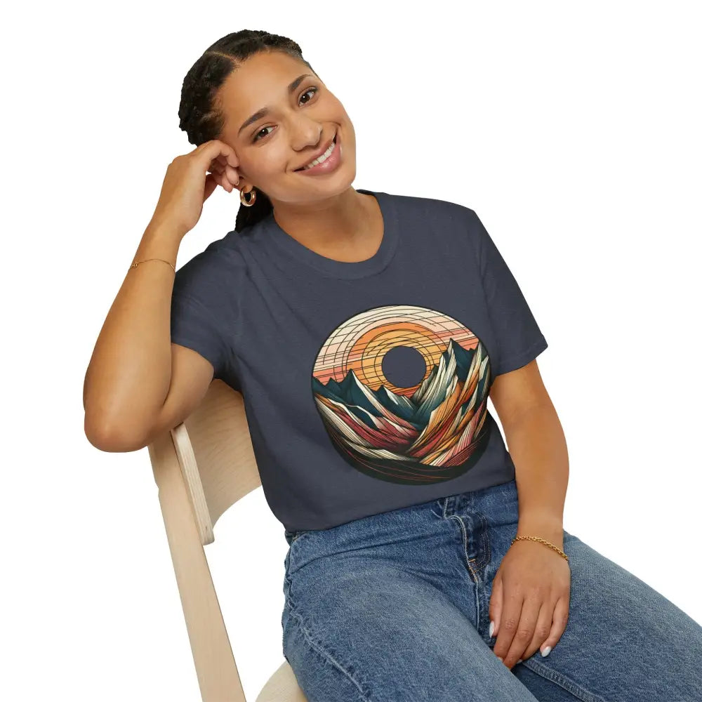 Smiling woman wearing a Vintage Mountain Vibes softstyle t-shirt with a colorful sunset graphic