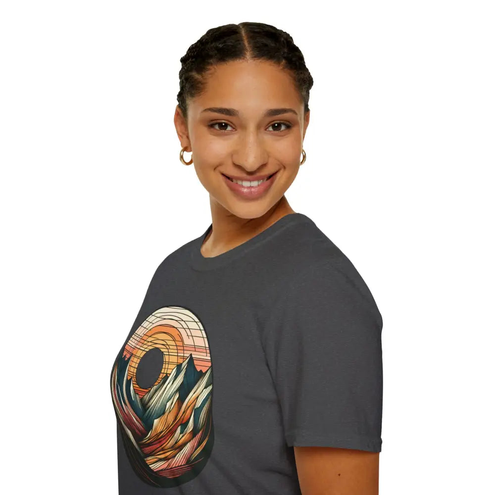 Woman in a dark gray softstyle t-shirt with mountain and sunset graphic, eco-friendly design