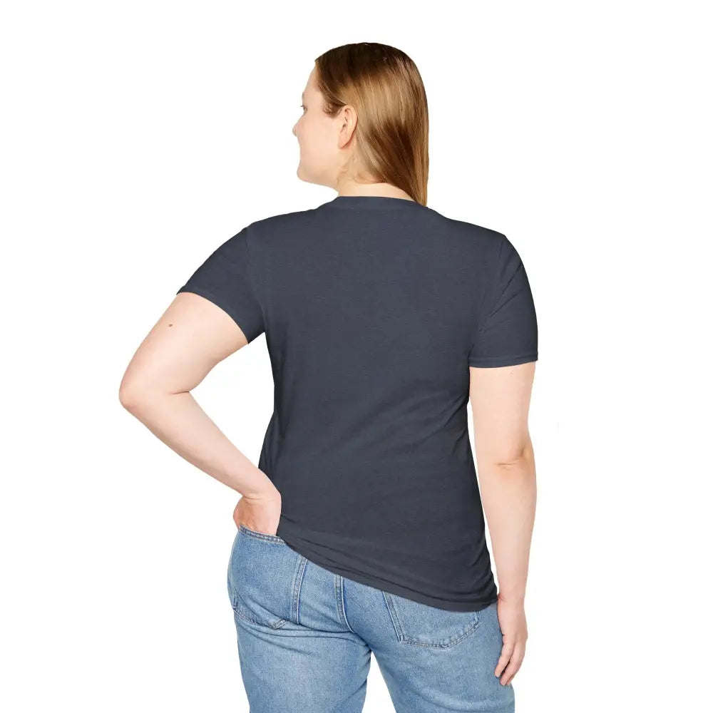 Woman wearing a dark gray softstyle t-shirt designed with an elastic ribbed collar and blue jeans