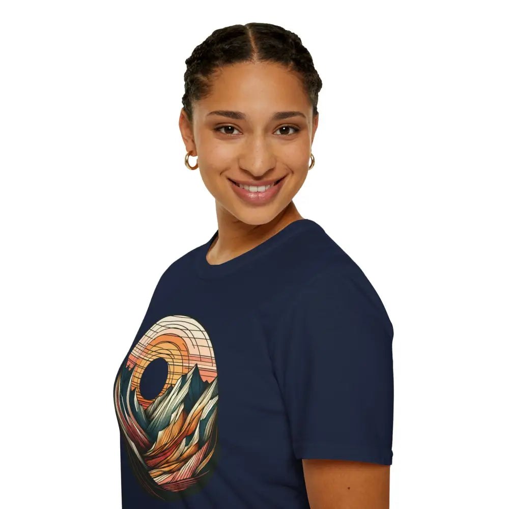 Woman wearing navy blue softstyle t-shirt with colorful mountain landscape graphic and elastic ribbed collar